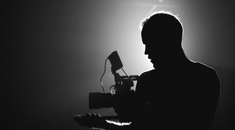 a videographer with camera pacing